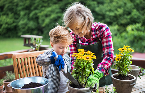 Woman and kid filling planters