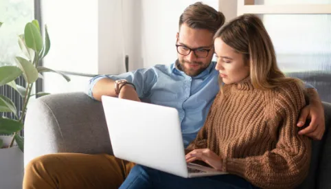 couple using laptop together