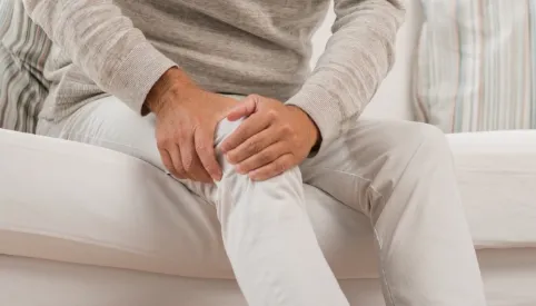 main holding painful knee