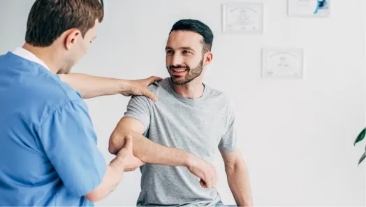 provider helping patient's arm