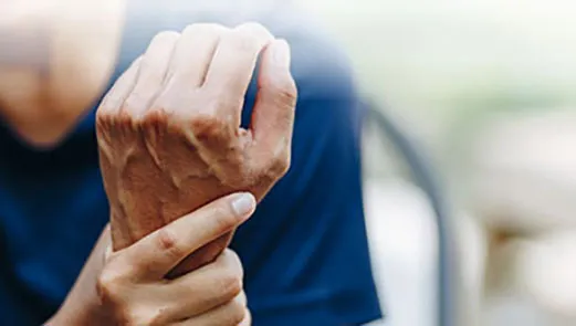 older woman holding painful wrist