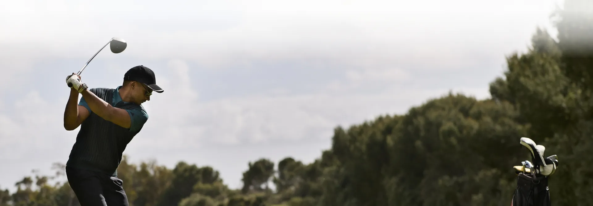 man golfing in mid swing