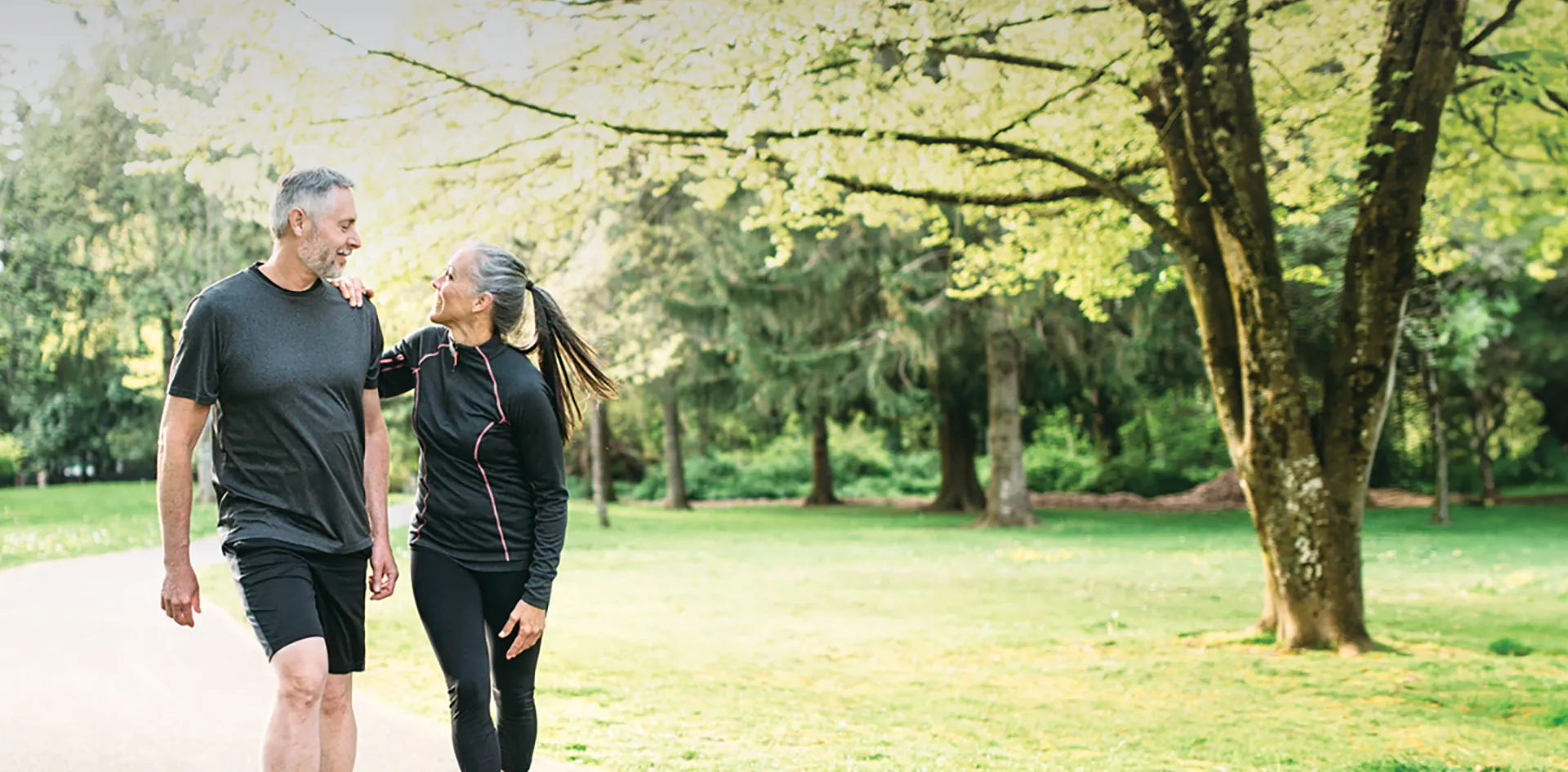 older couple walking in the park together