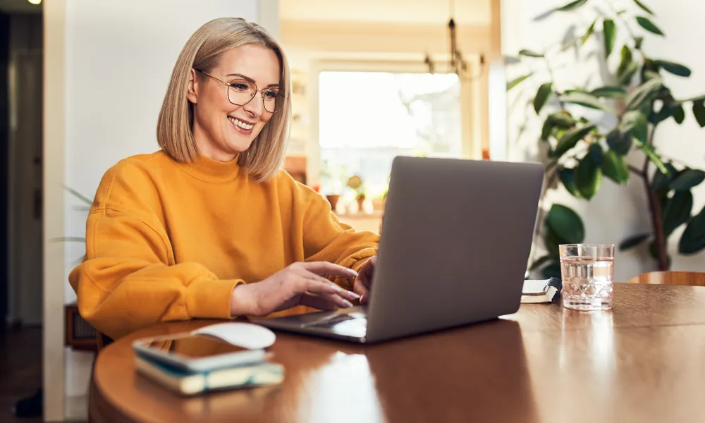 smiling woman using laptop