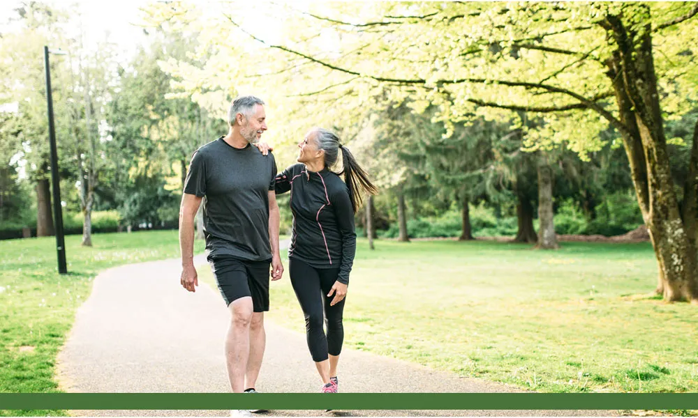 older couple walking in the park together